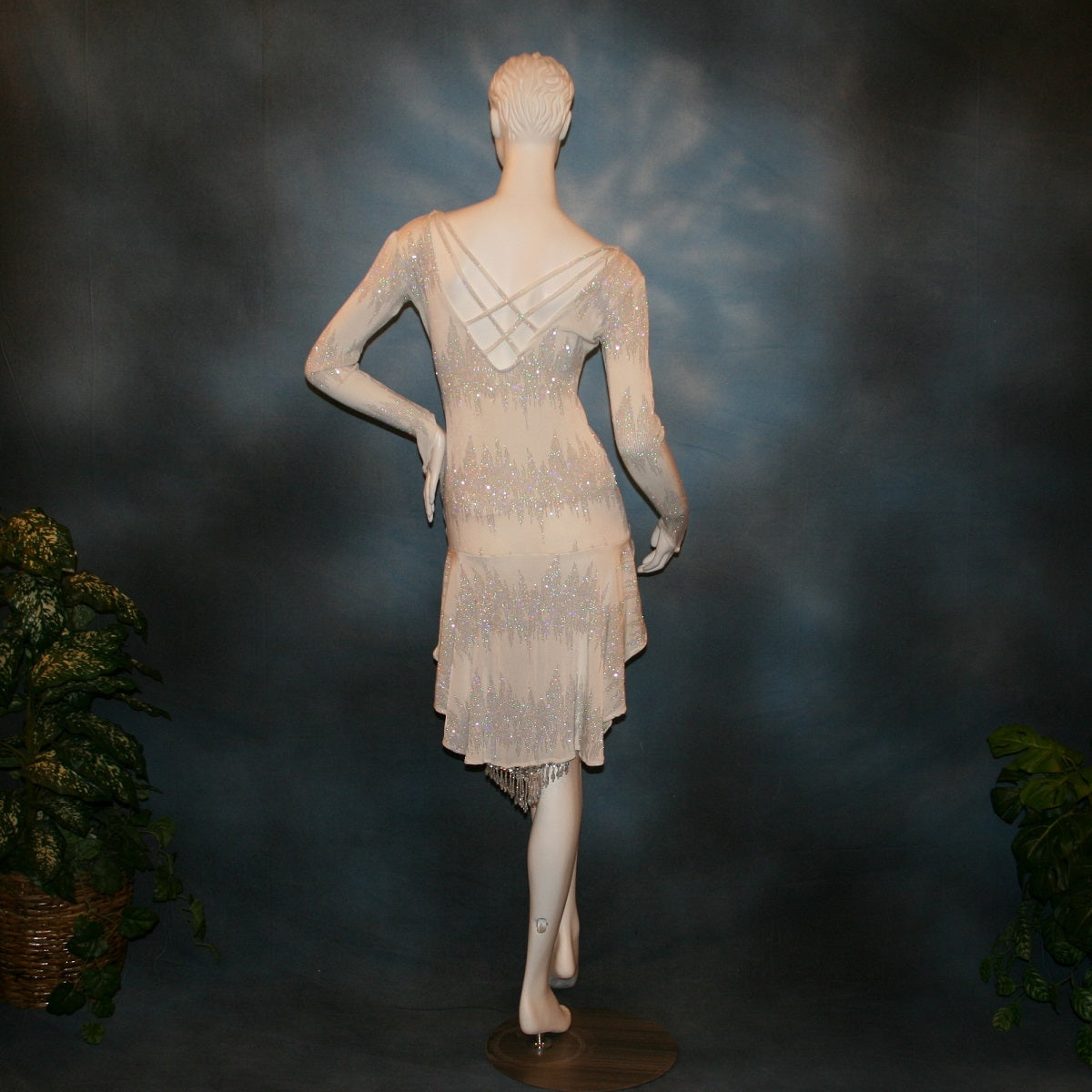 back view of White Latin/Rhythm dress created in glitter slinky with an awesome electrifying glitter pattern, features long sleeves, lattice strap details on back & a touch of Swarovski hand beading in the skirting.