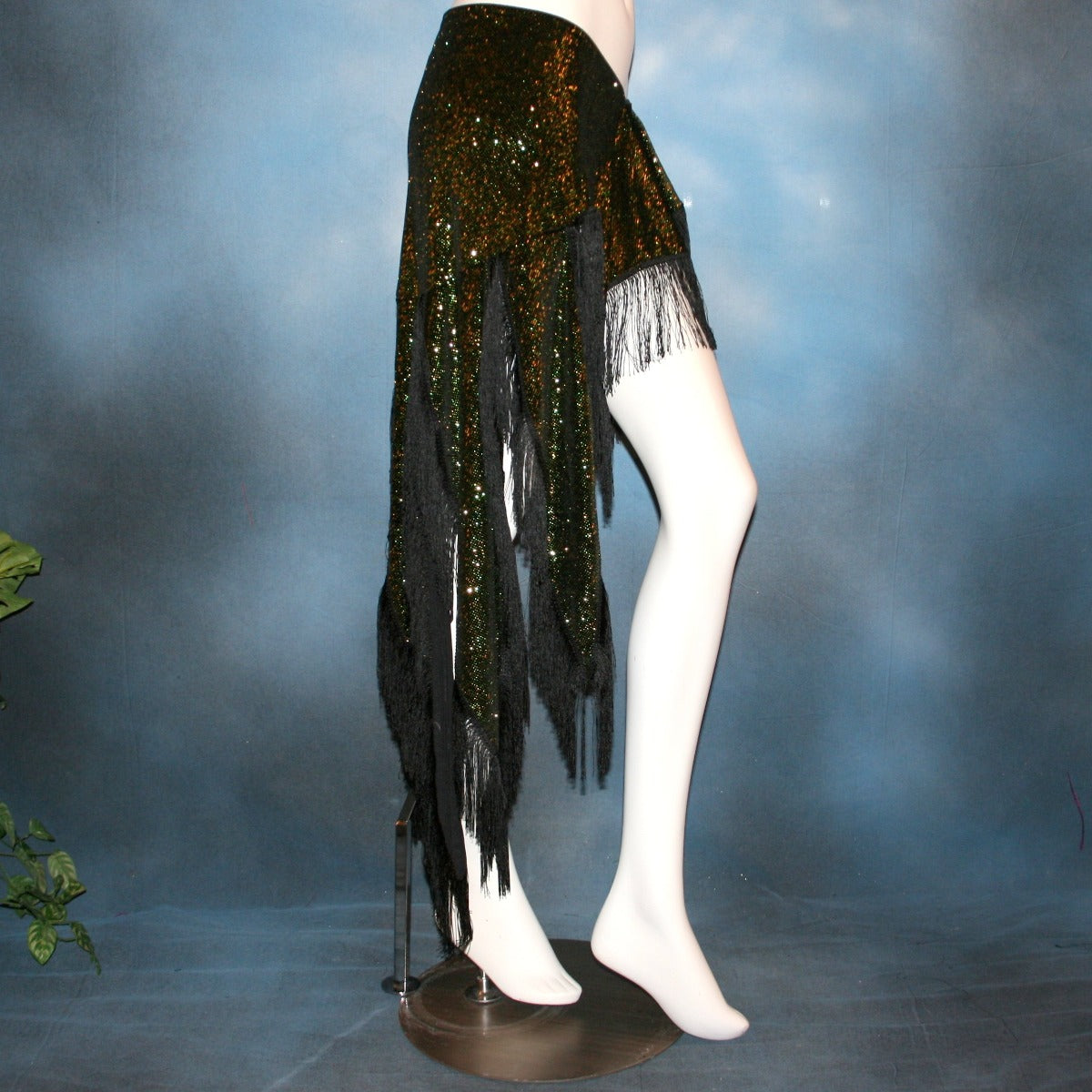 side view of Green Latin/skirt skirt, wrap style, was created with luxurious green glitter slinky & chainette fringe. There is just enough of the gorgeous fabric to custom create a bodysuit to go with it for an extra fee, possibly two...one on the simple classy side for ballroom social dances & the other could be more elaborate with Swarovski work for ballroom showcases or competitions, making it a converta ballroom dance set!