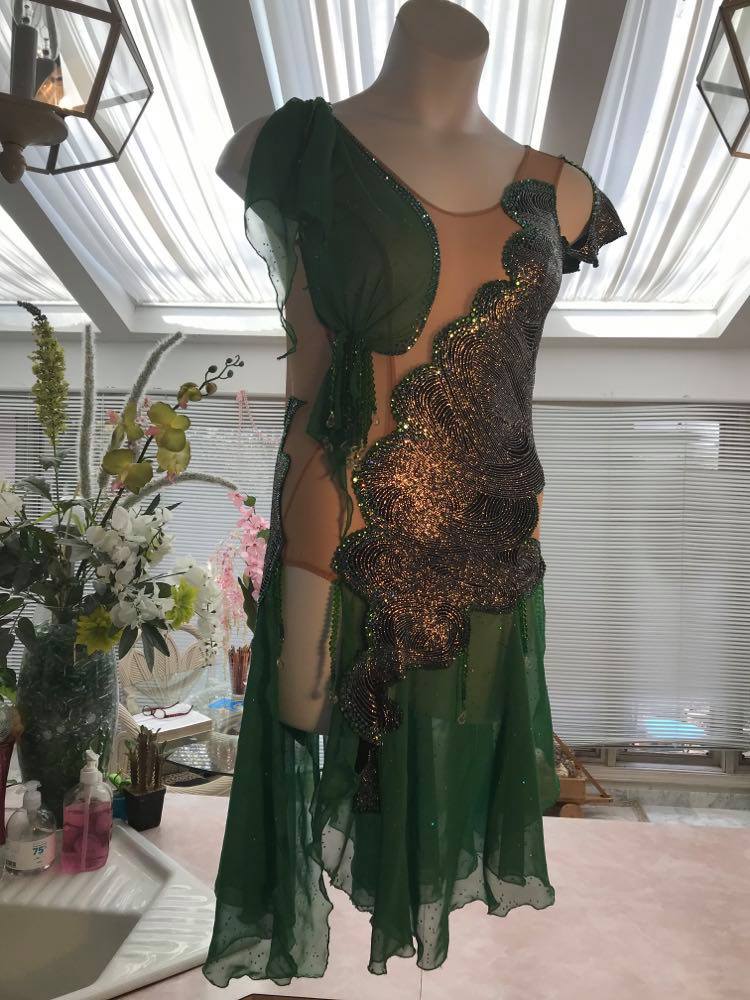 Crystal's Creations silver Latin/rhythm dress with emerald green accents created of intricately cut & artistically placed silver swirls glitter slinky on a nude illusion base, with skirting & accent pieces of an emerald green size 5/6-9/10