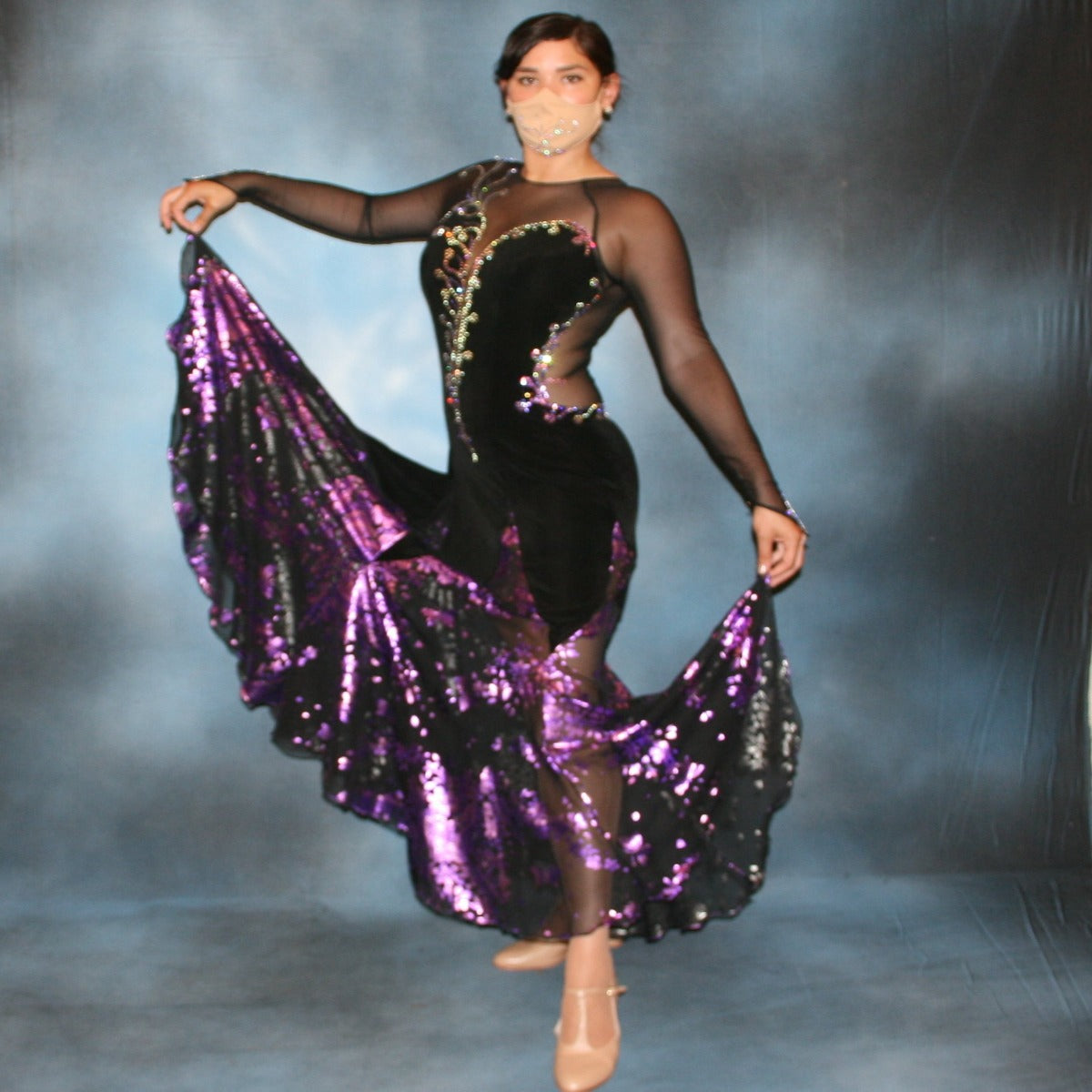 Crystal's Creations Black ballroom dance dress with purple accents was created in luxurious black solid slinky on stretch mesh base figure contouring bodysuit, featuring yards of black & purple metallic print chiffon, enhanced with intricately detailed tanzinite & vitrail light Swarovski rhinestone work.