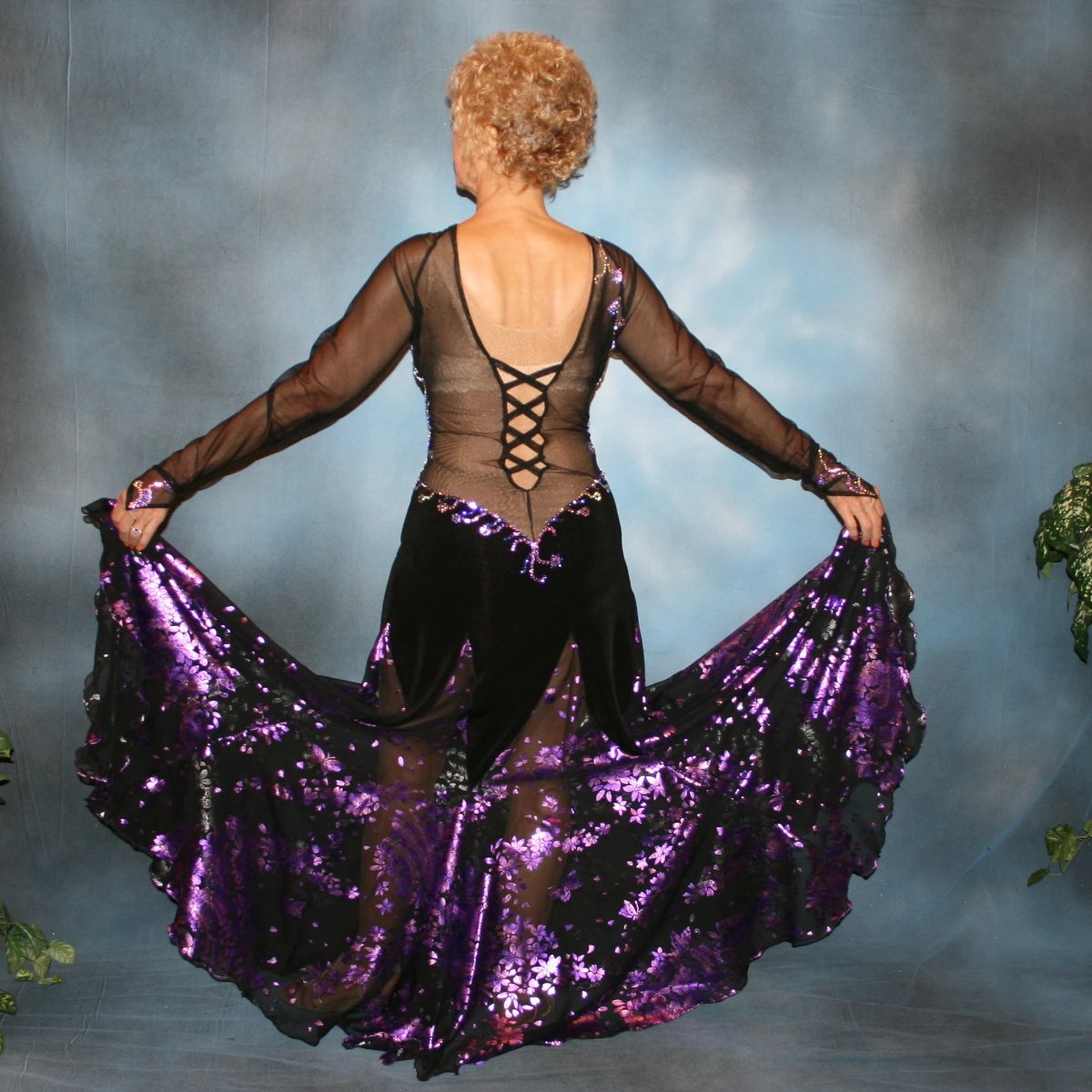 Crystal's Creations back view of Black ballroom dance dress with purple accents was created in luxurious black solid slinky on stretch mesh base figure contouring bodysuit, featuring yards of black & purple metallic print chiffon, enhanced with intricately detailed tanzinite & vitrail light Swarovski rhinestone work.