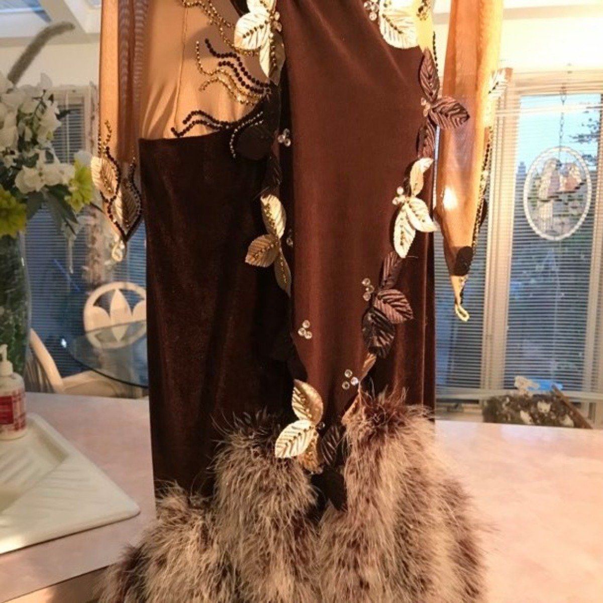 Crystal's Creations close bottom view of brown Latin/rhythm dress created in luxurious chocolate brown stretch velvet & luxurious solid chocolate brown slinky on a nude illusion base, embellished with delicate silk leaves, as well as gold aurum & mocca Swavski detailed rhinestone work, size 1/2-5/6