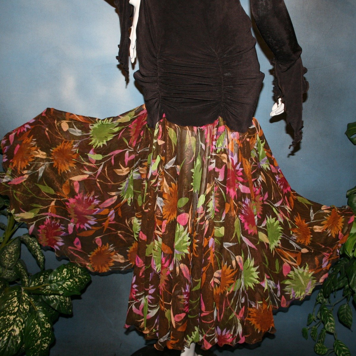 Crystal's Creations lower back view of Deep chocolate brown social ballroom dress created of luxurious deep chocolate brown solid slinky base featuring ruching through the hip area, & interesting long flared sleeves, with yards of fall colored flowers chiffon petal panels