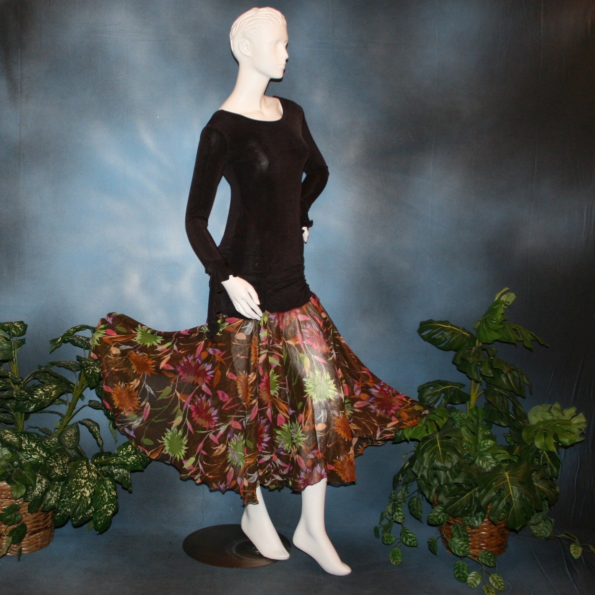 Crystal's Creations side view of Deep chocolate brown social ballroom dress created of luxurious deep chocolate brown solid slinky base featuring ruching through the hip area, & interesting long flared sleeves, with yards of fall colored flowers chiffon petal panels