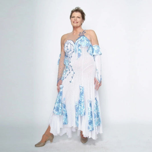 White ballroom dress with blue accents was created on nude illusion of a soft white knit with flounce accents of sky blue & white floral print satin, embellished with sapphire Swarovski stonework & miniature white silk roses.