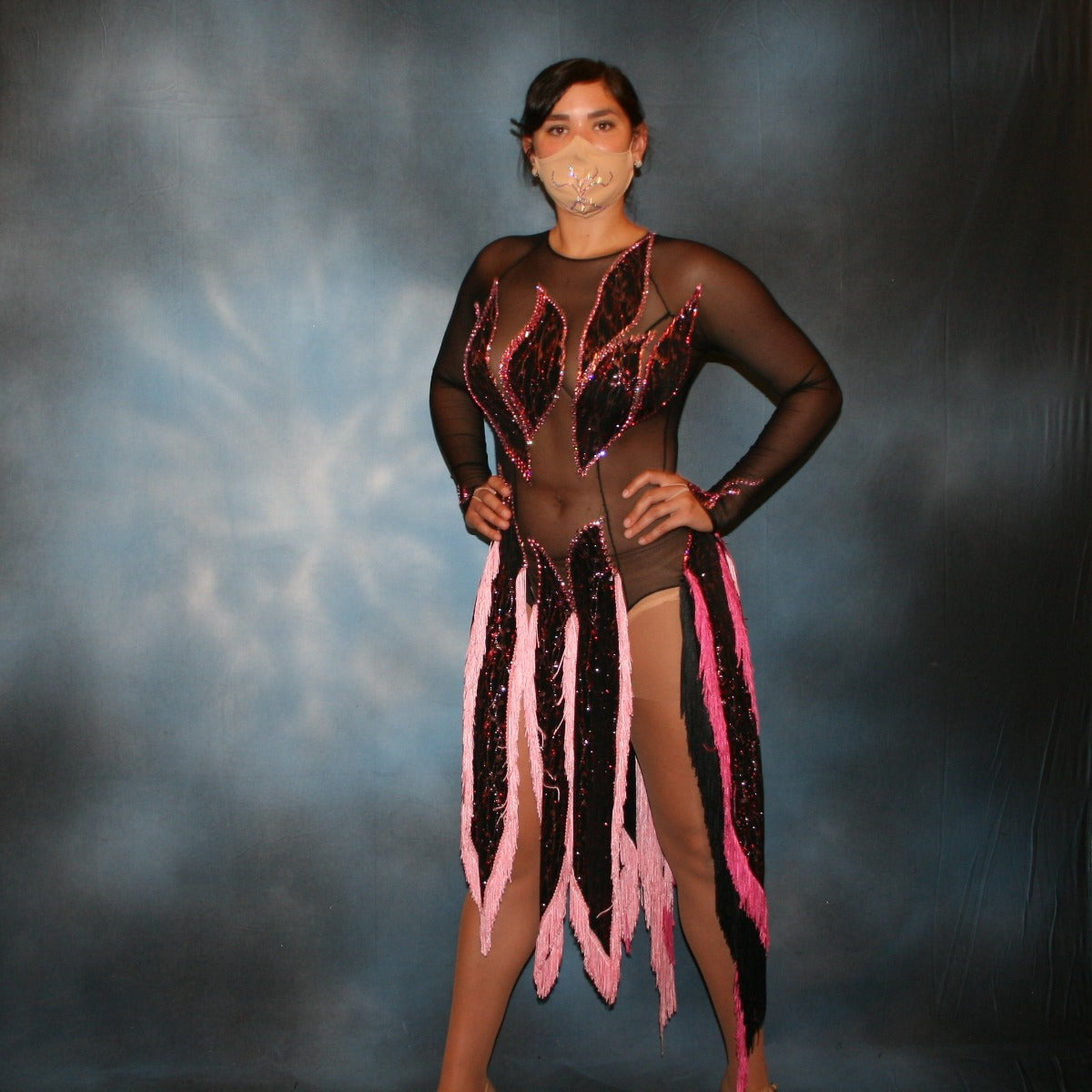 Crystal's Creations Black Latin/rhythm dress features hand cut flame type motifs of glitter slinky with red & pink delicate oriental print on black mesh base with several flame type panels with yards of pink chainette fringe creating the skirting…embellished with rose & light rose Swarovski rhinestones, about 13 gross.