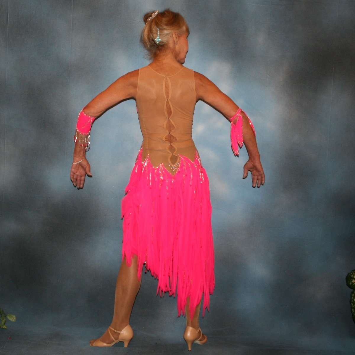 Crystal's Creations back view of Hot pink Latin dress created of hot pink tricot chiffon overlayed on nude illusion base with flame effect is embellished with CAB Sawovski rhinestones & hand beading on sale!