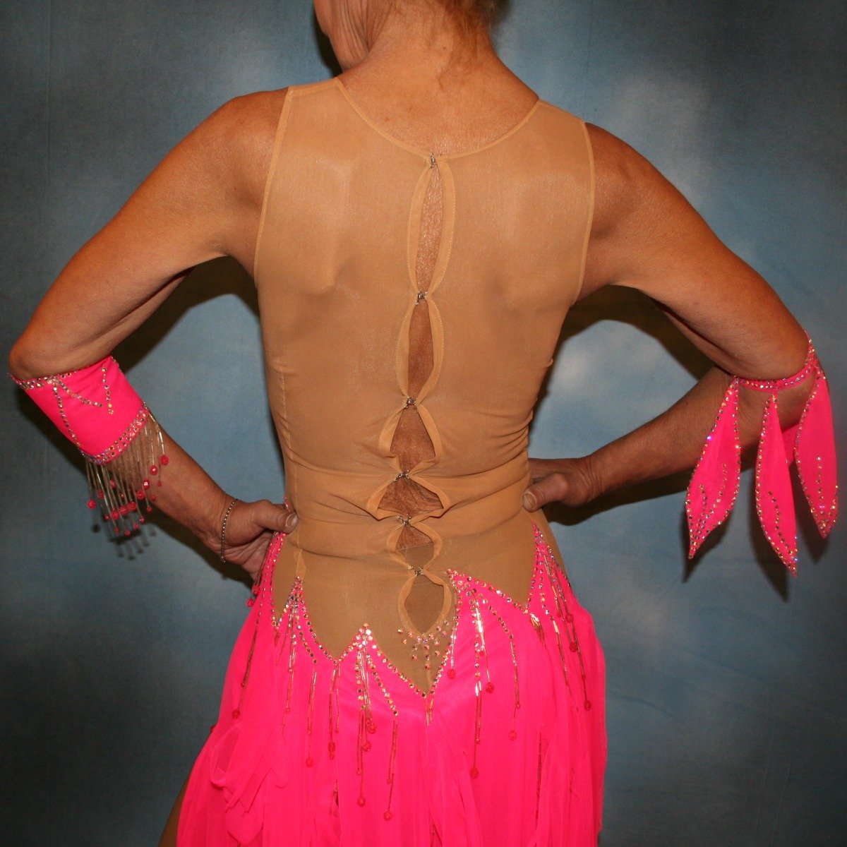 close back view of Hot pink Latin dress created of hot pink tricot chiffon overlayed on nude illusion base with flame effect is embellished with CAB Sawovski rhinestones & hand beading on sale!