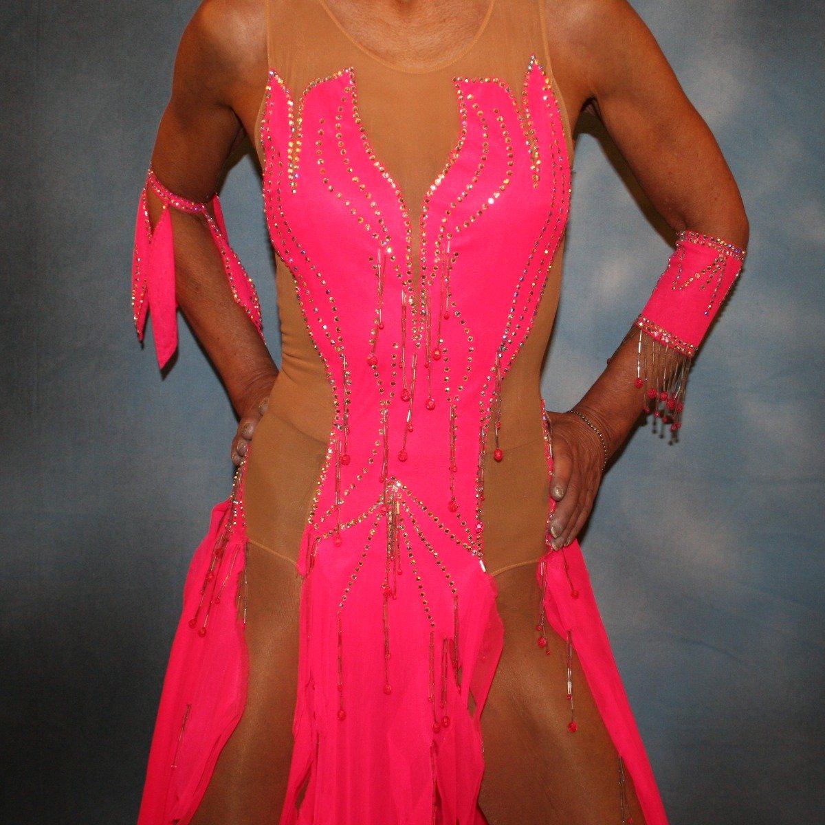 close view of Hot pink Latin dress created of hot pink tricot chiffon overlayed on nude illusion base with flame effect is embellished with CAB Sawovski rhinestones & hand beading on sale!