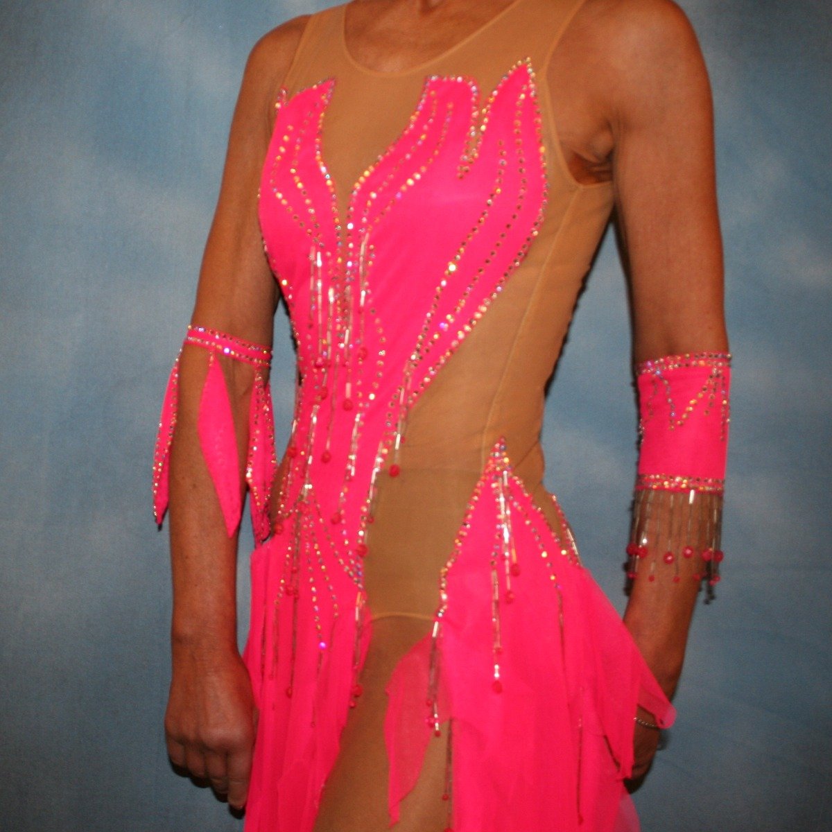 side view of Crystal's Creations Hot pink Latin dress created of hot pink tricot chiffon overlayed on nude illusion base with flame effect is embellished with CAB Sawovski rhinestones & hand beading on sale!