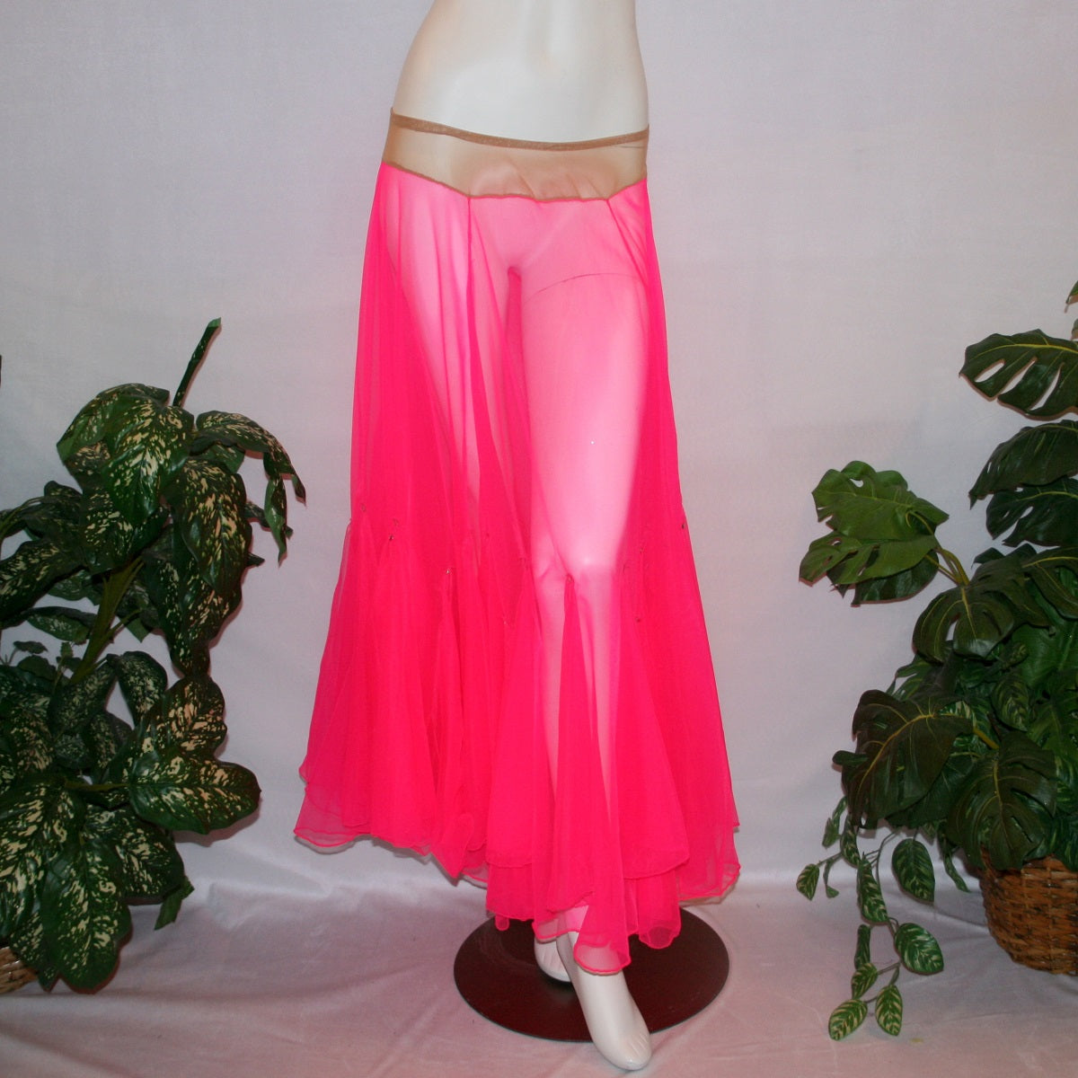 Hot pink ballroom skirt created with yards of hot pink sheer tricot with petal like floats around bottom embellished with tear drop Swarovski rhinestones.