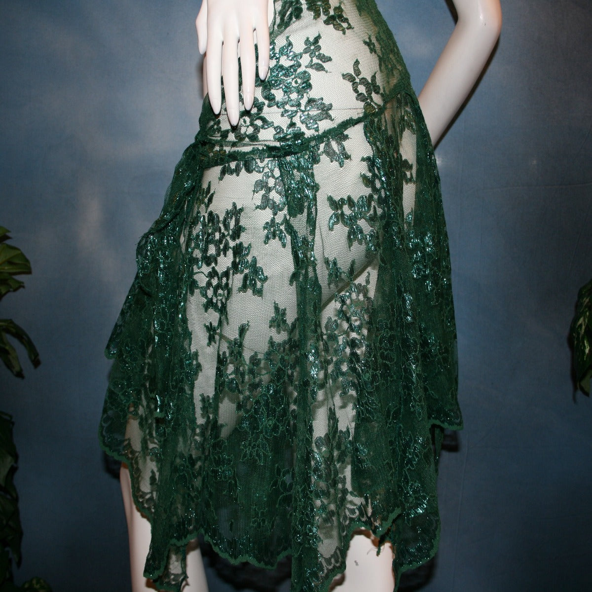 side view of Green lace short Latin/rhythm skirt, wrap style, was created with green metallic lace.