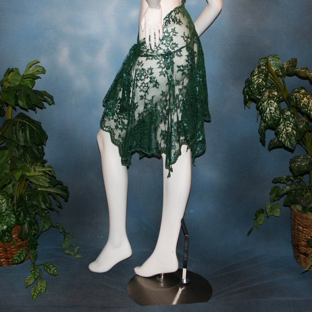 side view of Green lace short Latin/rhythm skirt, wrap style, was created with green metallic lace.