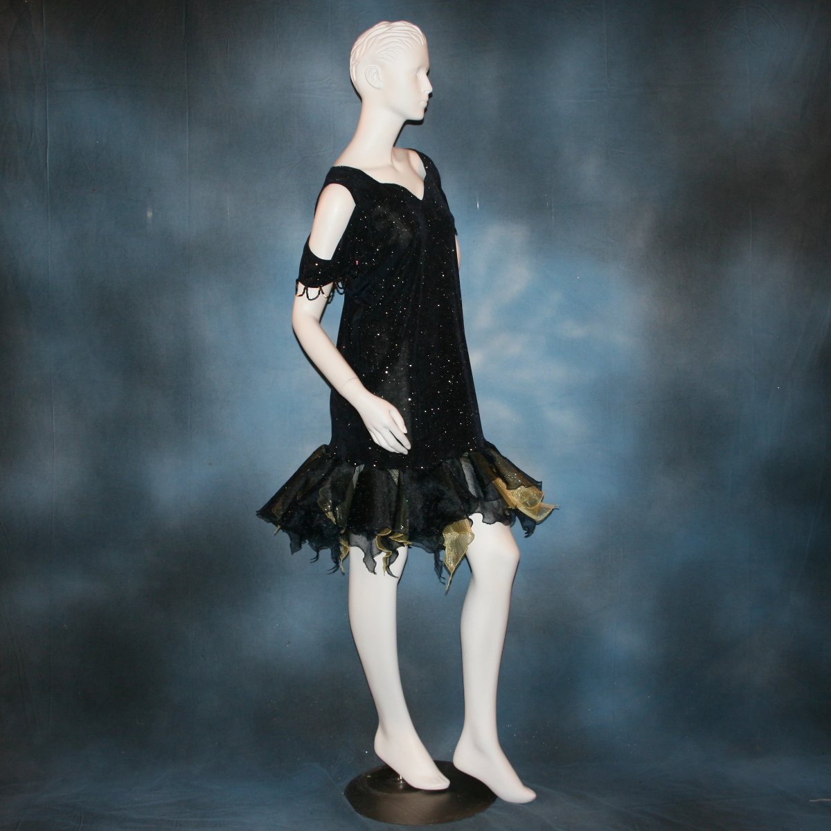 Crystal's Creations side view of Navy Latin/rhythm/social dance dress created in navy glitter slinky fabric with oodles of glitter organza flounces of navy & soft yellow, with hand beading at sleeve edges & back peek-a-boo. A great social ballroom dress for any special occasion, as well as a Latin/rhythm dance dress!