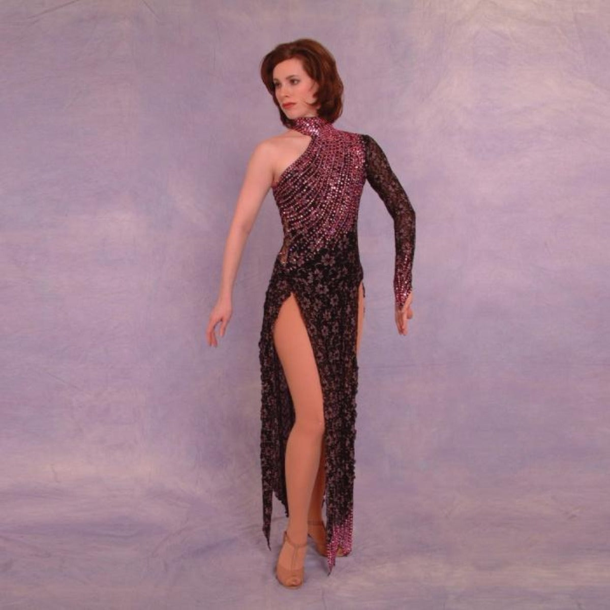 Crystal's Creations Stunning black long sleeve Latin/Rhythm dress was created in black & subtle pink stretch lace, & is embellished with over 25 gross of rose Swarovski rhinestones covering most of the bodice in a gorgeous wave pattern, featuring strap detailing on the back.