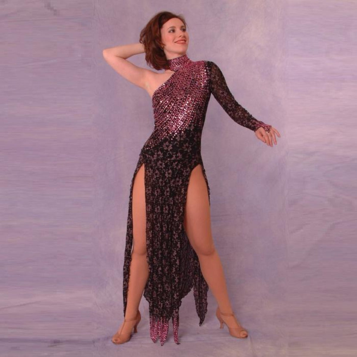 Crystal's Creations Stunning black long sleeve Latin/Rhythm dress was created in black & subtle pink stretch lace, & is embellished with over 25 gross of rose Swarovski rhinestones covering most of the bodice in a gorgeous wave pattern, featuring strap detailing on the back.