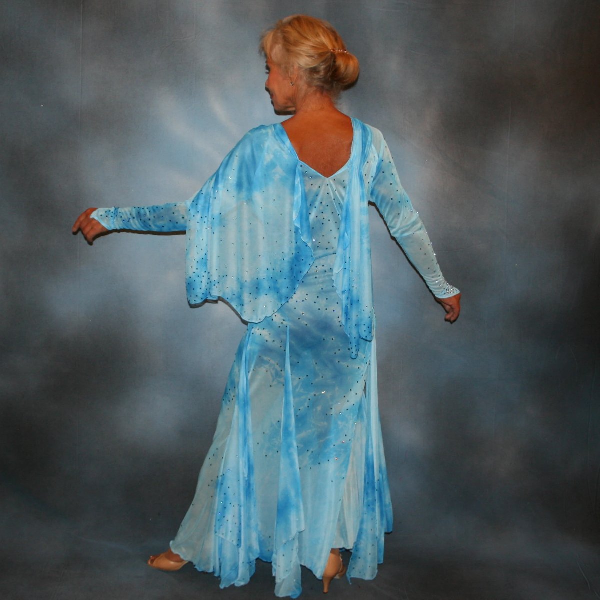 Crystal's Creations left back view of Elegant blue ballroom dress created in shades of blue printed semi sheer stretch with floats, fabulous for a solo ballroom dance or a theatrical ballroom number…embellished with Swarovski rhinestone work in shades of capri blue & aquamarine