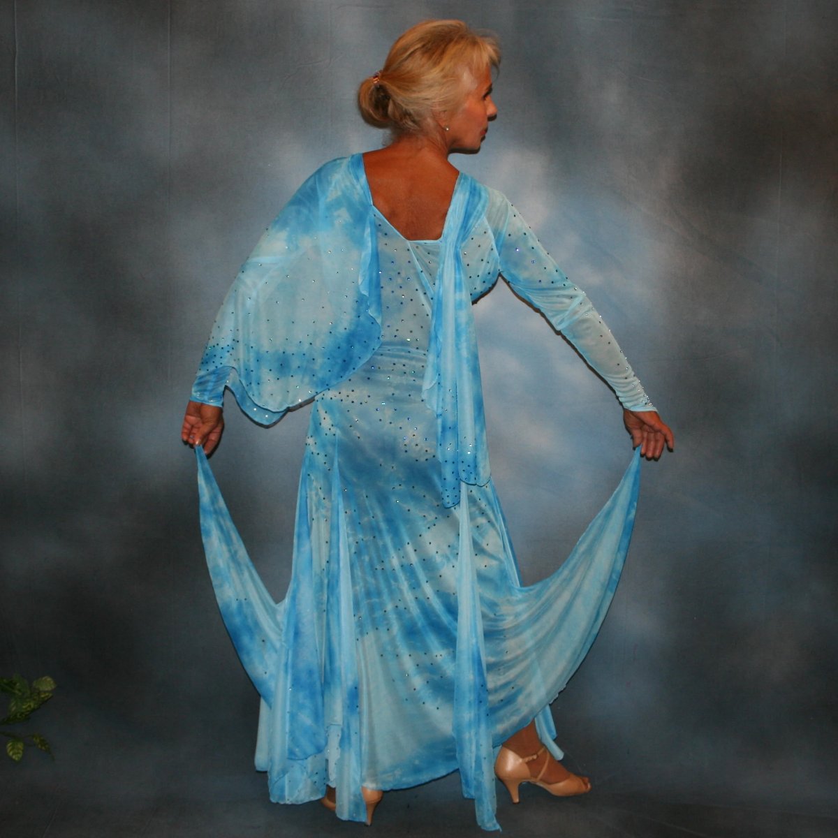 Crystal's Creations back view of Elegant blue ballroom dress created in shades of blue printed semi sheer stretch with floats, fabulous for a solo ballroom dance or a theatrical ballroom number…embellished with Swarovski rhinestone work in shades of capri blue & aquamarine