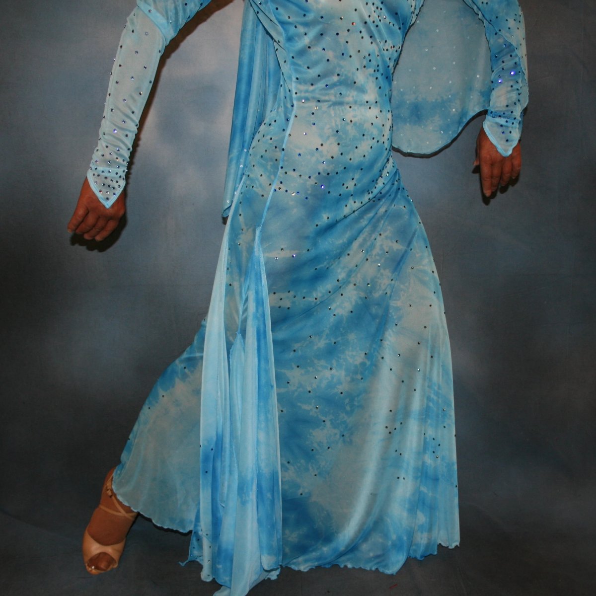 Crystal's Creations close up bottom view of Elegant blue ballroom dress created in shades of blue printed semi sheer stretch with floats, fabulous for a solo ballroom dance or a theatrical ballroom number…embellished with Swarovski rhinestone work in shades of capri blue & aquamarine