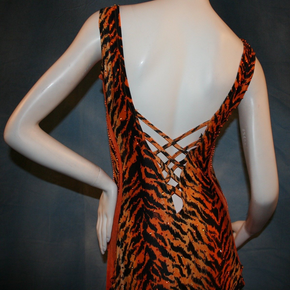 Crystal's Creations close up back view of orange & black tiger print Latin/rhythm dress with orange chandelle feathers & hand beading