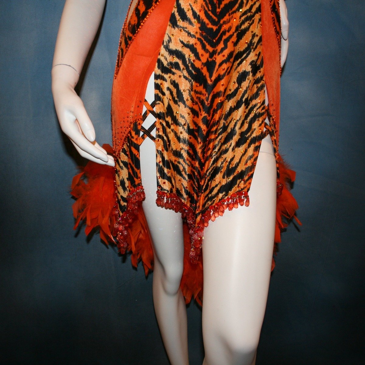 Crystal's Creations close up bottom view of orange & black tiger print Latin/rhythm dress with chandelle feathers & hand beading