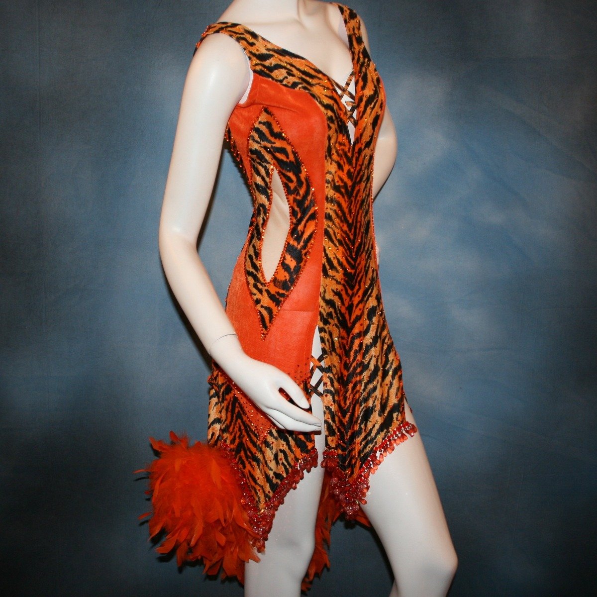 Crystal's Creations close up side view of orange & black tiger print Latin/rhythm dress with chandelle feathers & hand beading