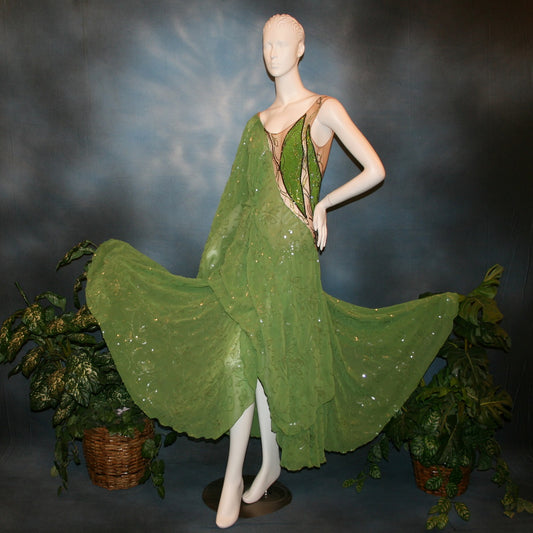 Crystal's Creations Green ballroom dress is created of a gorgeous apple green ivy/flower patterned sequined chiffon overlayed on a nude illusion base, embellished with rhinestone work in shades of ivy greens.