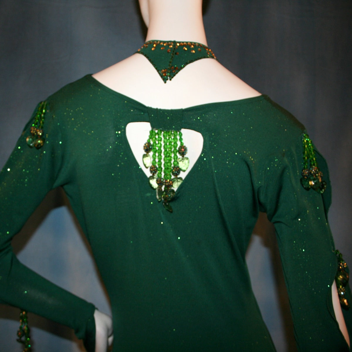 Crystal's Creations close up back view of Green Latin/rhythm dress was created in luxurious deep emerald glitter slinky, embellished with chandelle feathers & Swarovski hand beaded detailing. 