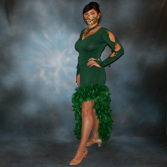 Crystal's Creations side view of Deep emerald green Latin/rhythm dress was created in luxurious deep emerald glitter slinky, embellished with chandelle feathers & Swarovski hand beaded detailing. It includes a matching choker with gold aurum Swarovski rhinestone work & hand beading, size 5/6-11/12, very stretchy