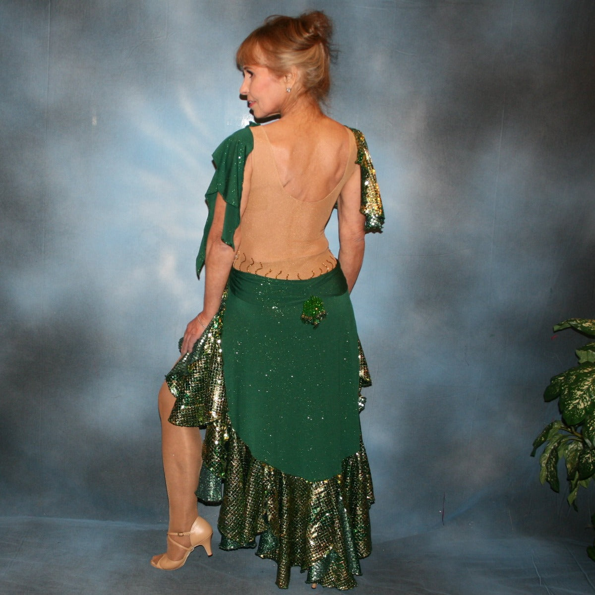 Crystal's Creations back view of Green Latin/rhythm dress was created on a nude illusion base of deep emerald green glitter slinky fabric along with flounces & accents of rich emerald green & gold tropical print sequin fabric, embellished with gold aurum Swarovski stonework plus hand beaded detailing.