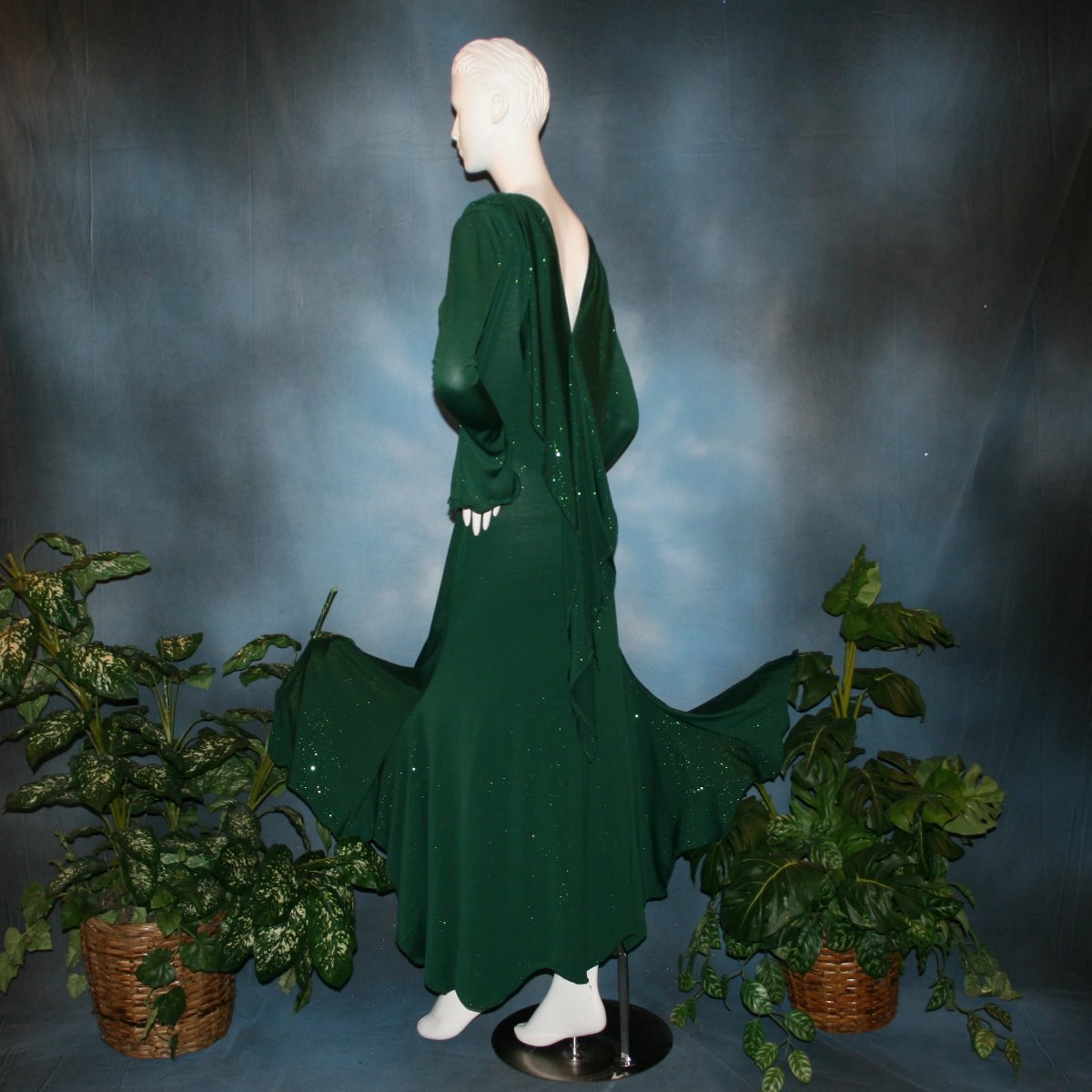Crystal's Creations side view of Green social ballroom dress was created in luxurious deep emerald glitter slinky, with full  & flaring skirt bottom, long flair sleeves & draping trailing down the back makes this gorgeous dress very elegant & classy!