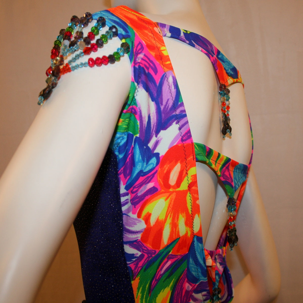 shoulder details on Tropical print Latin-rhythm dress created in tropical print lycra with side color blocking in deep purple glitter slinky with lots or flounces, back detailing, embellishing with Swarovski hand beading.