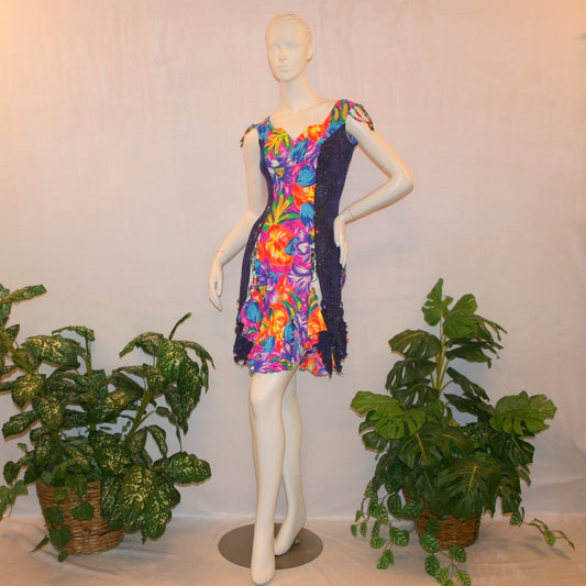 Tropical print Latin-rhythm dress created in tropical print lycra with side color blocking in deep purple glitter slinky with lots or flounces, back detailing, embellishing with Swarovski hand beading.