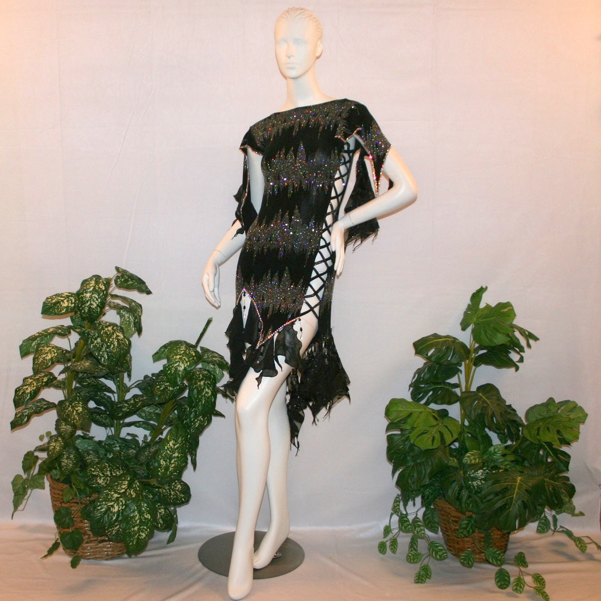 Black Latin-rhythm dress, which is also fabulous for tango, created in black glitter slinky with an awesome electrifying silver AB glitter pattern, features lattice detailing in the left side, asymmetrical cap draping sleeves, flounces, with Swarovski hand beading & Crystal Ab rhinestone work