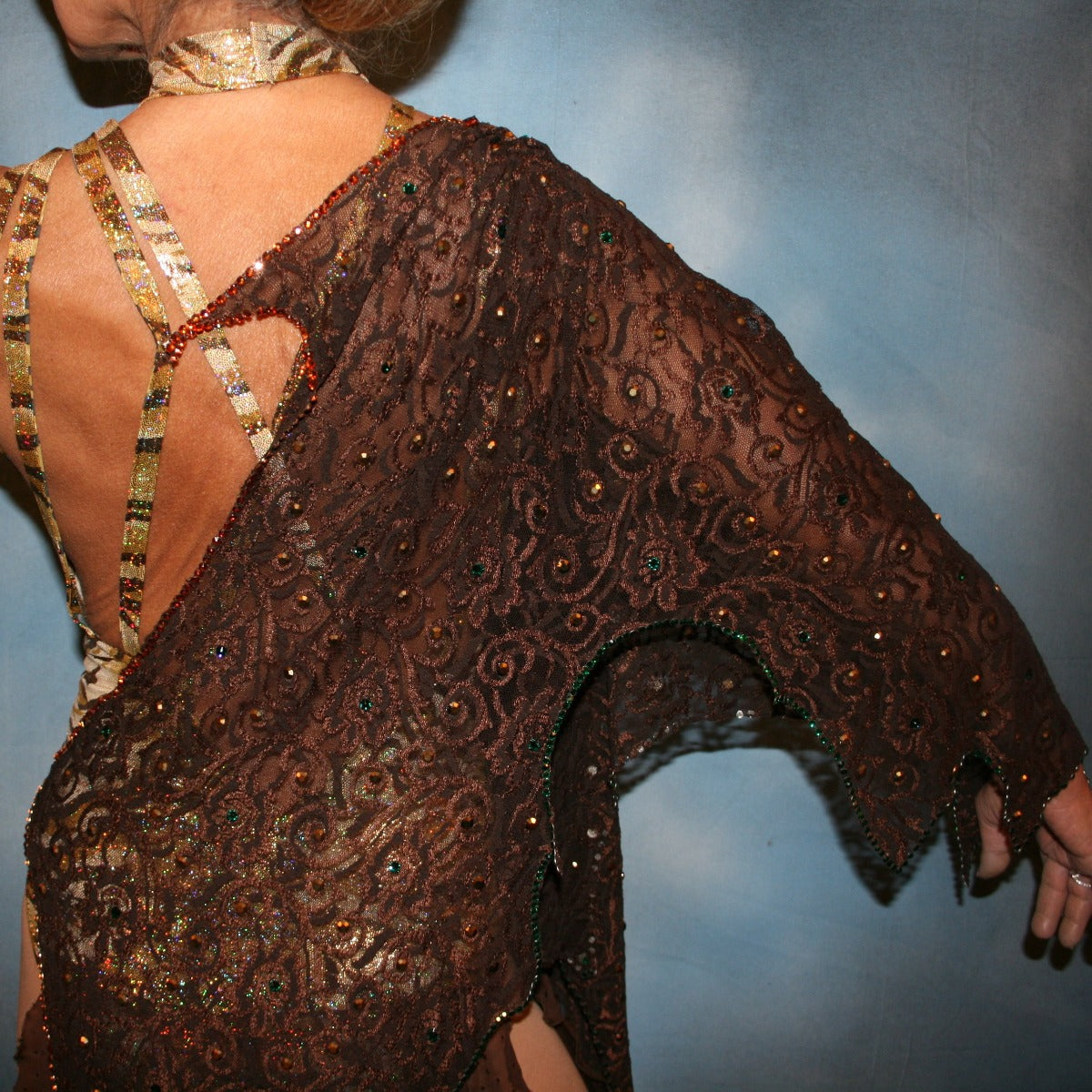 Crystal's Creations close up back view of Gold tango dress or Latin/rhythm dress created in chocolate brown stretch lace that is lavishly embellished with gold & a touch of emerald green Swarovski rhinestones overlayed & draped over a golden hologram tiger print bodysuit size 3/4-9/10