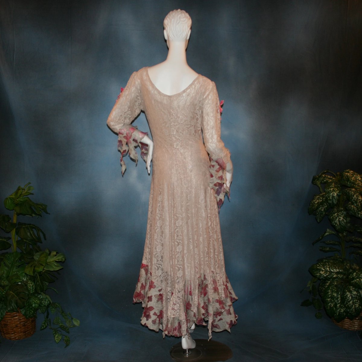 back view of Soft beige social ballroom dress created of beige stretch lace with oodles of beige & pink flower print semi-sheer flounces, a touch of pink silk flowers with beading, & under slip dress. A great beginner ballroom dance show dress!