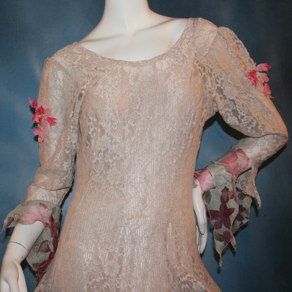 close upper view of Soft beige social ballroom dress created of beige stretch lace with oodles of beige & pink flower print semi-sheer flounces, a touch of pink silk flowers with beading, & under slip dress. A great beginner ballroom dance show dress!