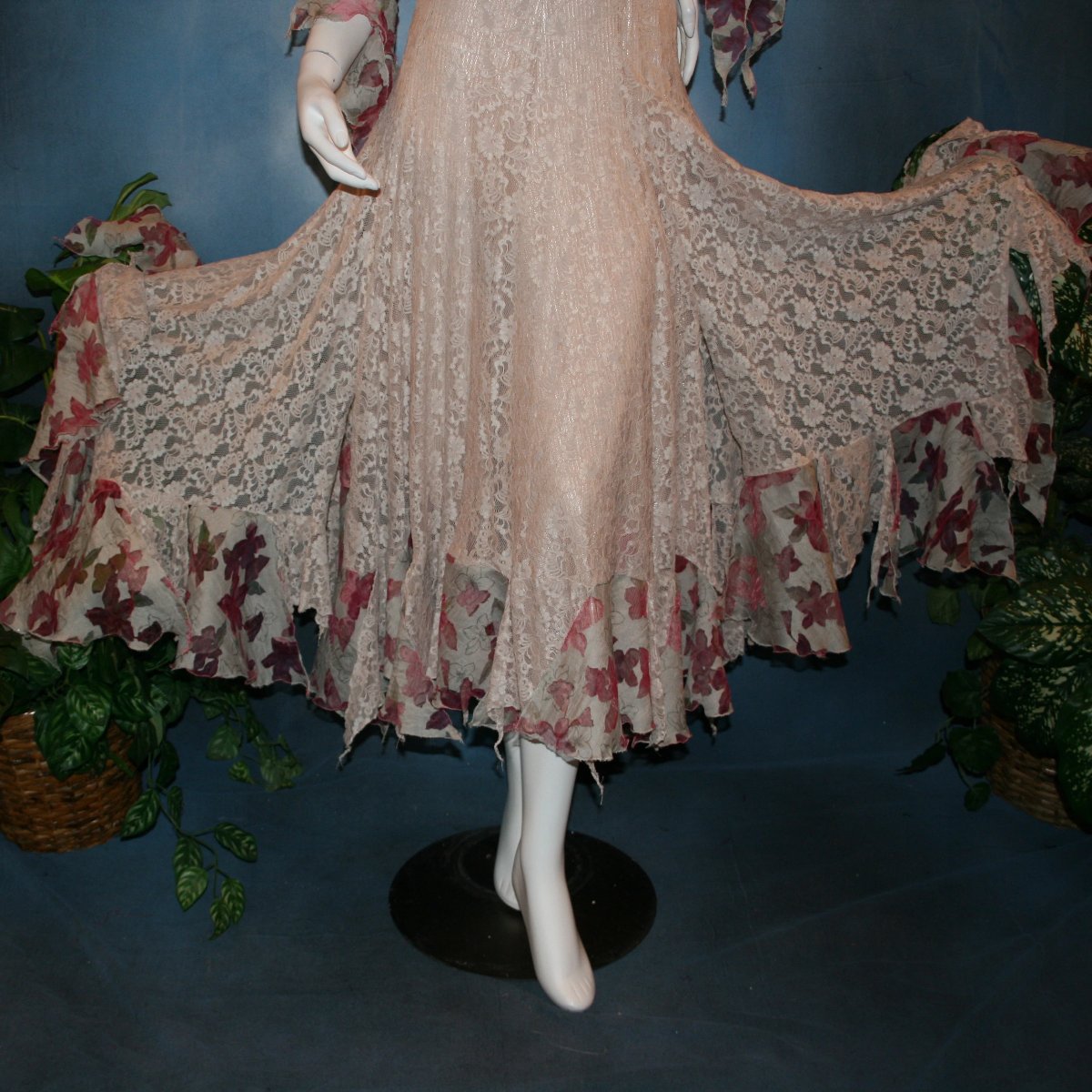 lower view of Soft beige social ballroom dress created of beige stretch lace with oodles of beige & pink flower print semi-sheer flounces, a touch of pink silk flowers with beading, & under slip dress. A great beginner ballroom dance show dress!