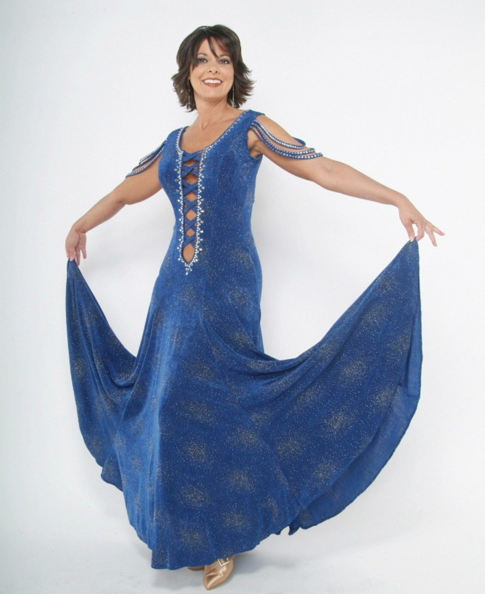 Crystal's Creations Blue ballroom dress created of royal blue glitter slinky, has lattice strap detailing, delicate strap arm draping embellishments and is embellished with CAB Swarovski rhinestone work.