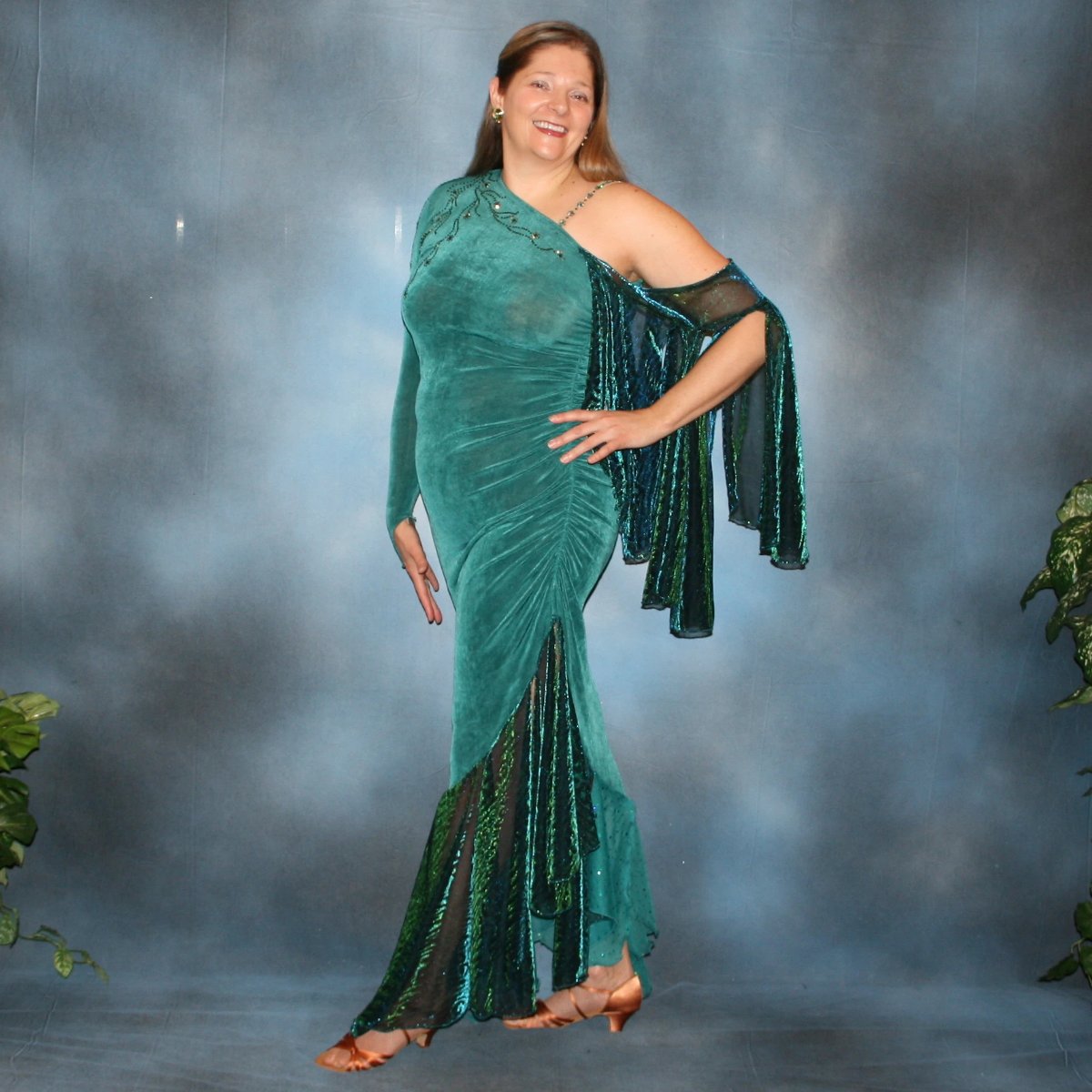 Crystal's Creations Plus size teal Latin/rhythm dress or tango dress was created in luxurious teal solid slinky with iridescent floats & flounces plus a few champagne sequined flounces at bottom skirting. It is embellished with finely detailed Swarovski stonework in blue zircon, blue zircon AB and emerald. green