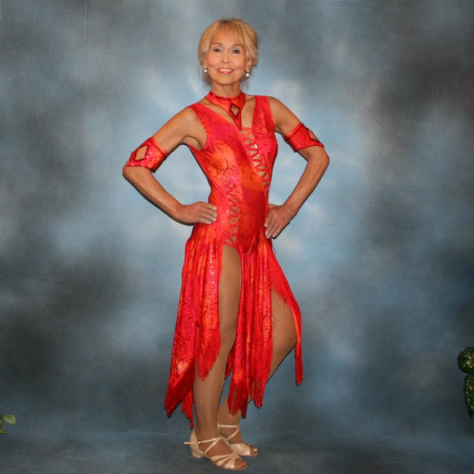 Crystal's Creations Red Latin/rhythm dress with fringe, created in a gorgeous Lava hologram metallic lycra of reds, oranges & a touch of yellow, features intricut strapping/lattice detail in design along with several panels bordered with red silky fringe. Neckpiece & arm bands are embellished with siam Swarovski rhinestones.