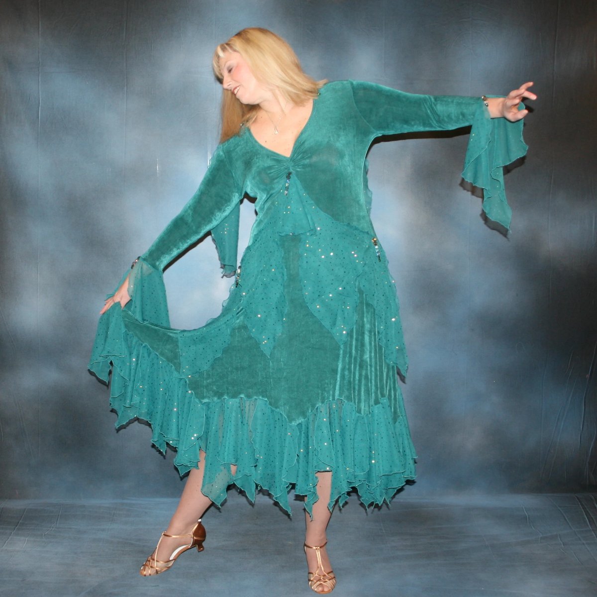 Teal plus size ballroom dance dress was created in luxurious teal solid slinky with oodles of champagne sequined chiffon flounces & floats, embellished with a lovely touch of Swarovski hand beading. on blonde model