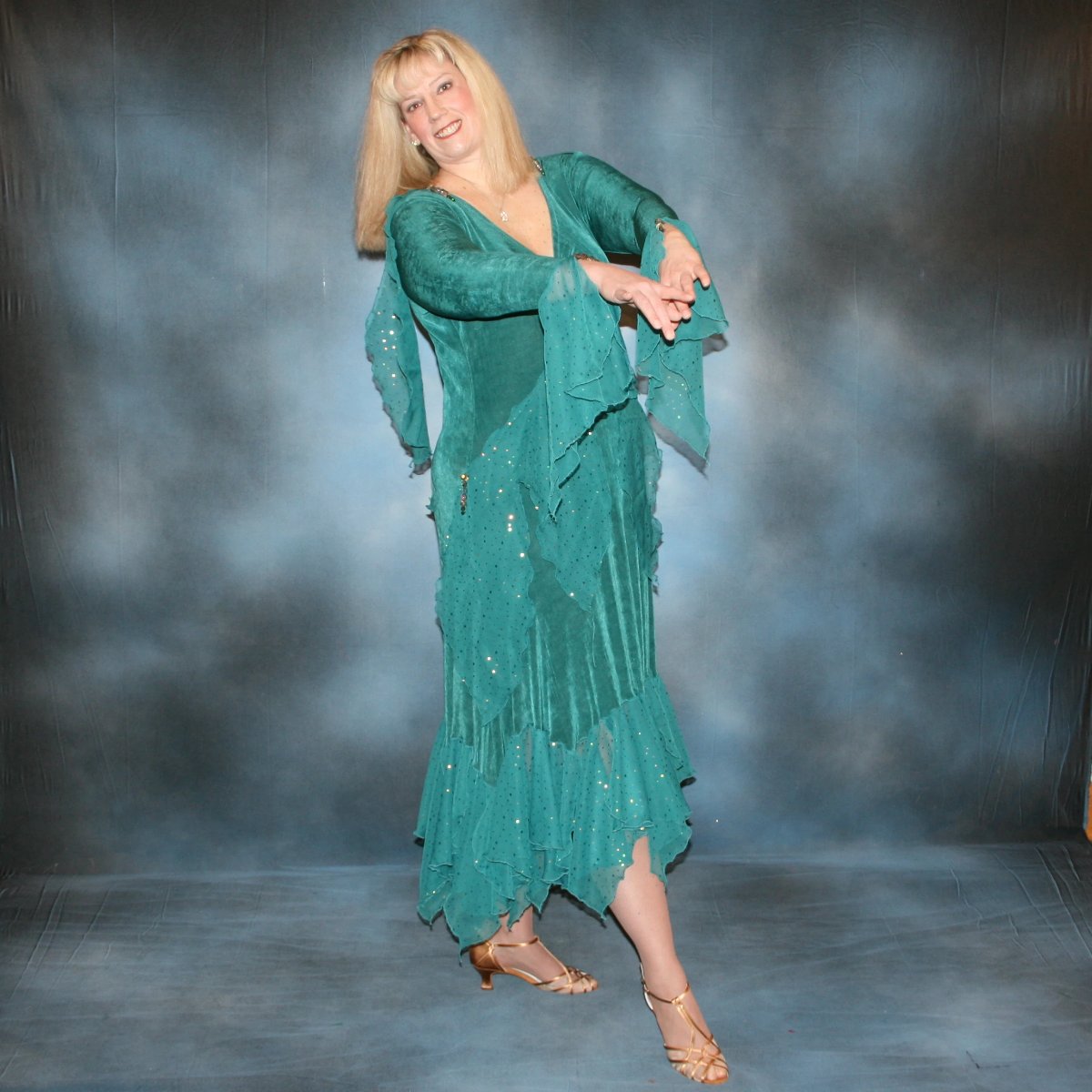 another view of Teal plus size ballroom dance dress was created in luxurious teal solid slinky with oodles of champagne sequined chiffon flounces & floats, embellished with a lovely touch of Swarovski hand beading on a blonde model