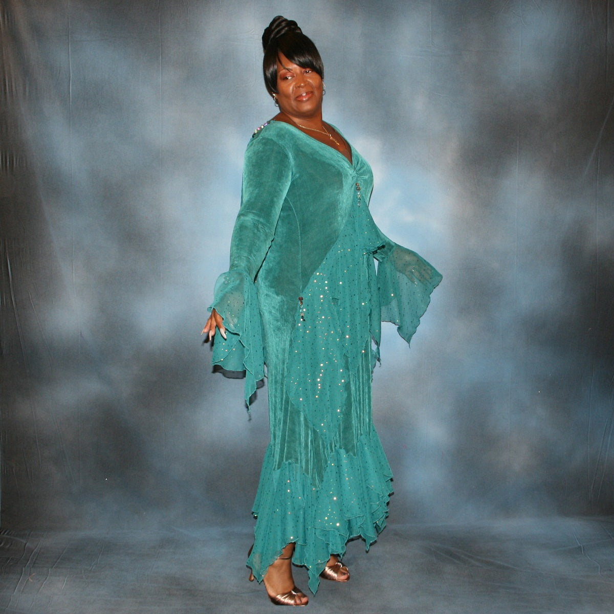 side view of Teal plus size ballroom dance dress was created in luxurious teal solid slinky with oodles of champagne sequined chiffon flounces & floats, embellished with a lovely touch of Swarovski hand beading.