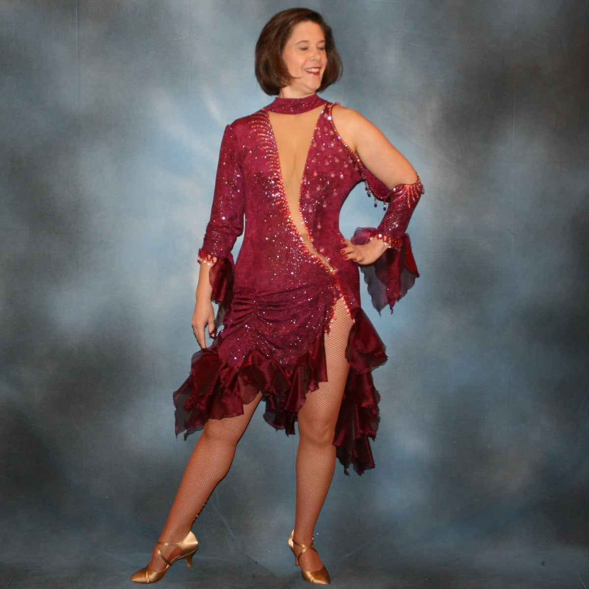 Crystal's Creations Burgundy Latin/rhythm dress created of burgundy glitter slinky with flounces of burgundy organza, embellished with light rose Ab Swarovski rhinestone work along with light rose extensive Swarovski hand beading