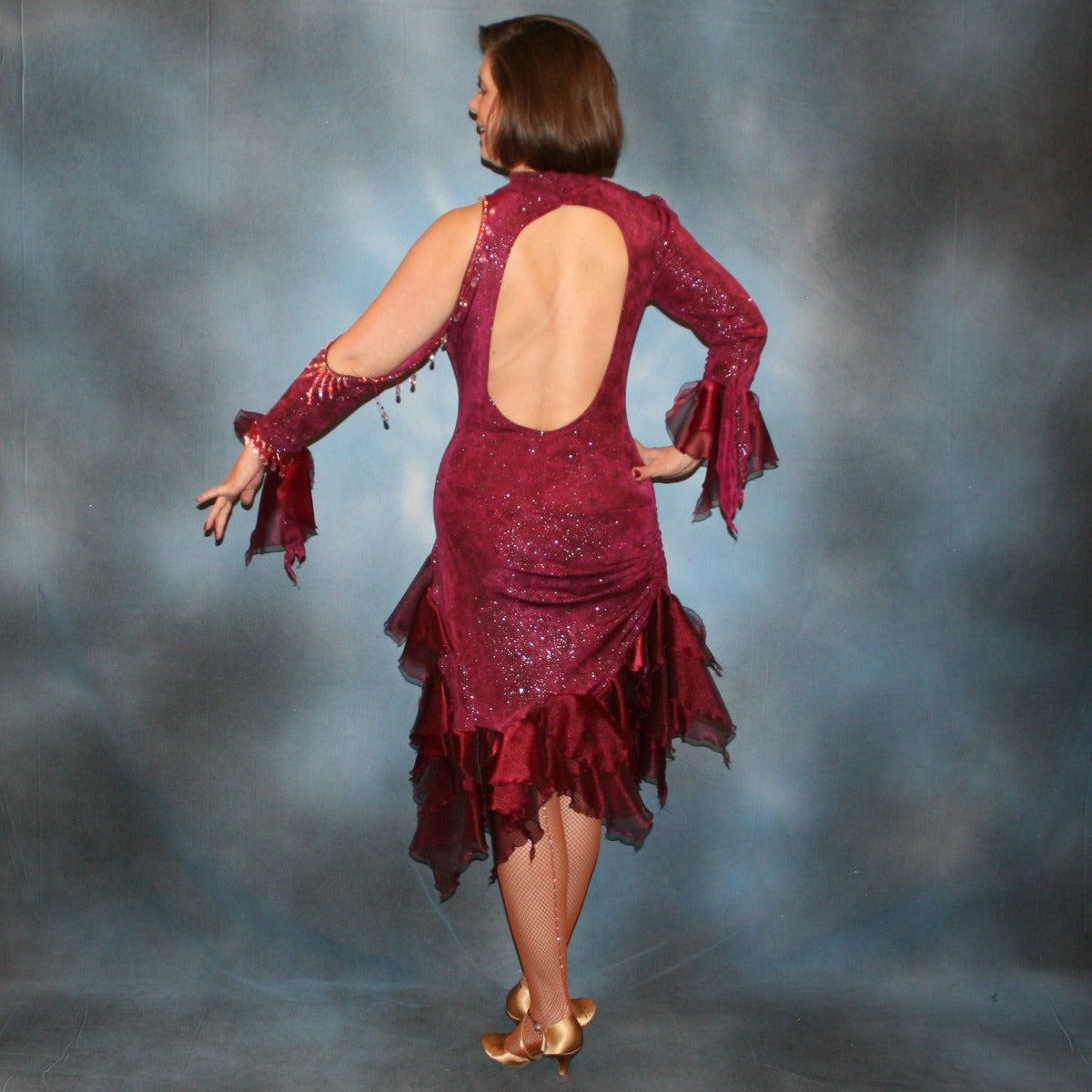 Crystal's Creations back view of Burgundy Latin/rhythm dress created of burgundy glitter slinky with flounces of burgundy organza, embellished with light rose Ab Swarovski rhinestone work along with light rose extensive Swarovski hand beading