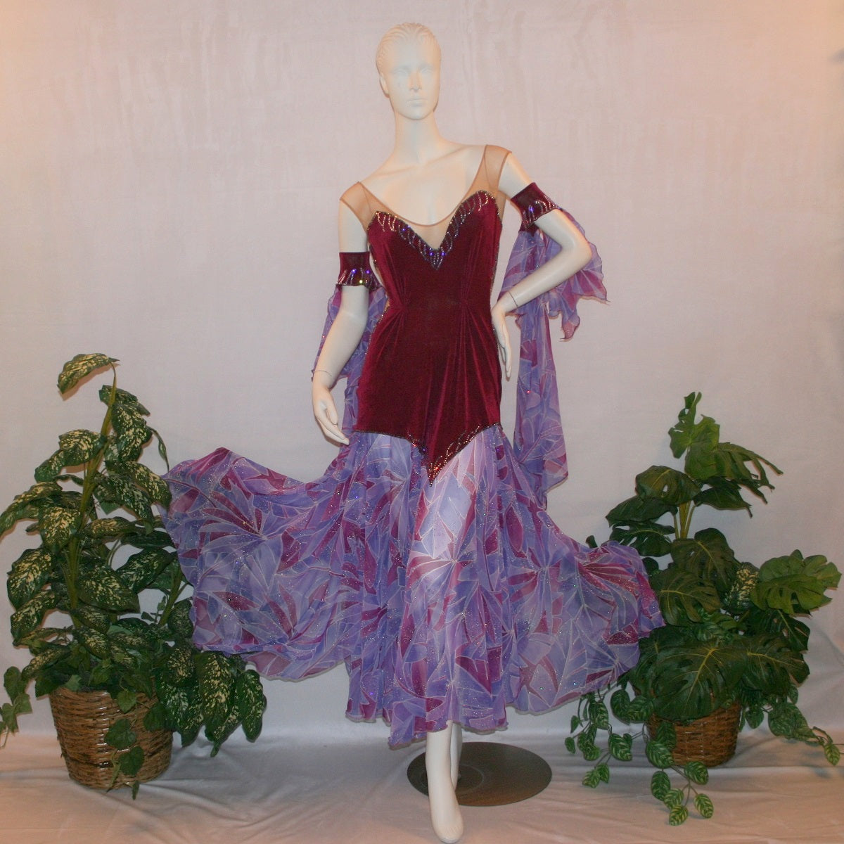 Crystal's Creations Magenta converta ballroom dress created of magenta solid slinky on a nude illusion base with tropical chiffon print skirtings of magenta & orchids, is embellished with tanzanite & orchid rhinestone work.
