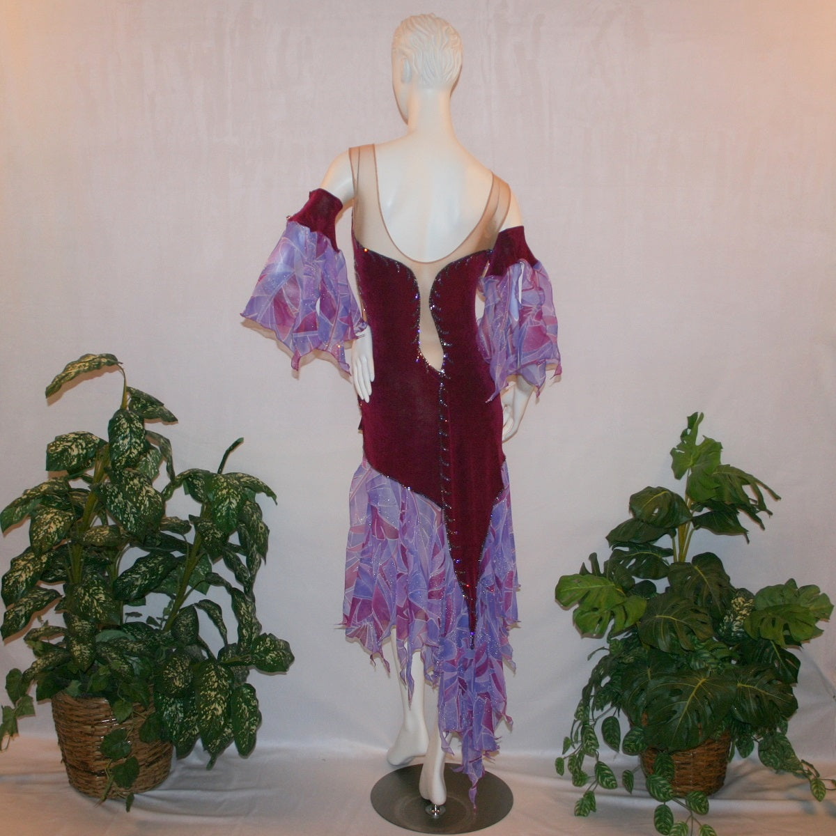 Crystal's Creations back view of Latin-rhythm dress portion of Magenta converta ballroom dress created of magenta solid slinky on a nude illusion base with tropical chiffon print skirtings of magenta & orchids, is embellished with tanzanite & orchid rhinestone work.