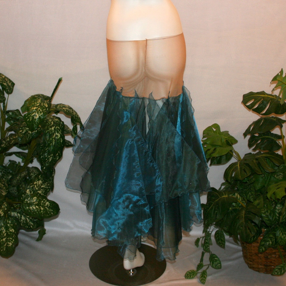 back view of Blue ballroom skirt created with yards of a deep sea blue organza, layers of large petal shaped panels.