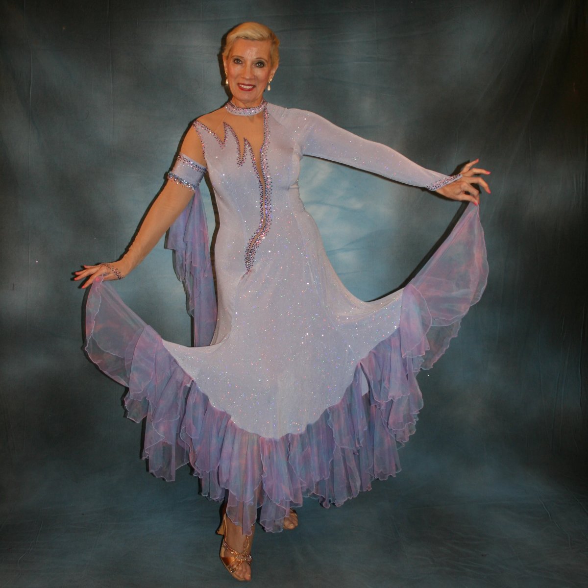 Crystal's Creations Blue ballroom dress created in periwinkle blue luxurious glitter slinky on nude illusion base with tricot chiffon flounces in shades of perwinkle & soft pink